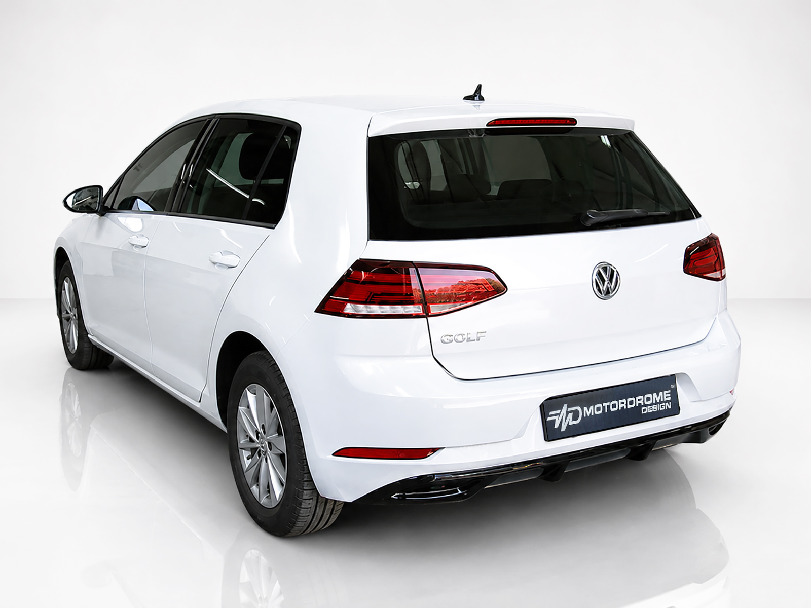 K156-002_1jpg - OPSHOLDERS White Volkswagen Golf hatchback shown from the rear-left in a studio, highlighting the taillights, VW emblem, and 'GOLF' badge.