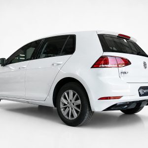 K156-002_3jpg - OPSHOLDERS White Volkswagen Golf hatchback photographed from the rear three-quarter angle in a studio setting, showing the VW badge and taillights.