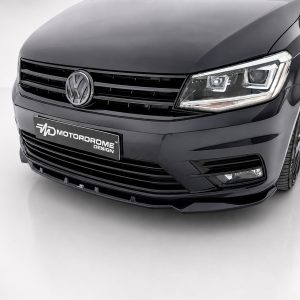 Front view of a black VW car with a bold grille and modern headlight design, displaying a Motordrome Design plate on the bumper