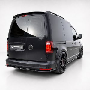 Black VW van viewed from the rear-right, featuring large black alloy wheels and a glossy finish with a Motordrome Design badge on the back door.