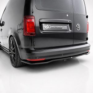 Rear of a black VW van with a Motordrome Design badge on the tailgate and custom body kit.