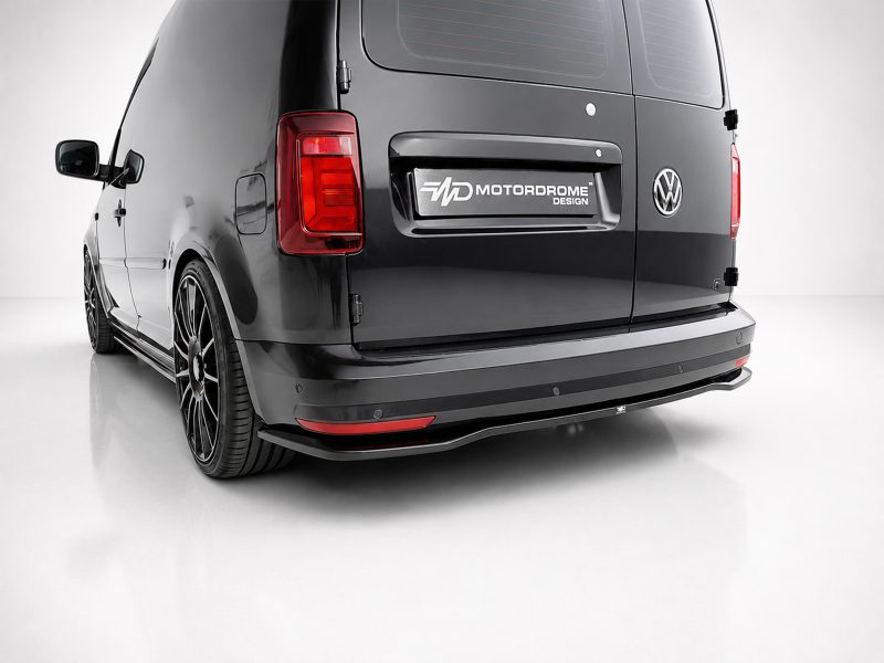 Rear of a black VW van with a Motordrome Design badge on the tailgate and custom body kit.
