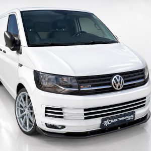 Front three-quarter view of a white Volkswagen cargo van in a studio setting.