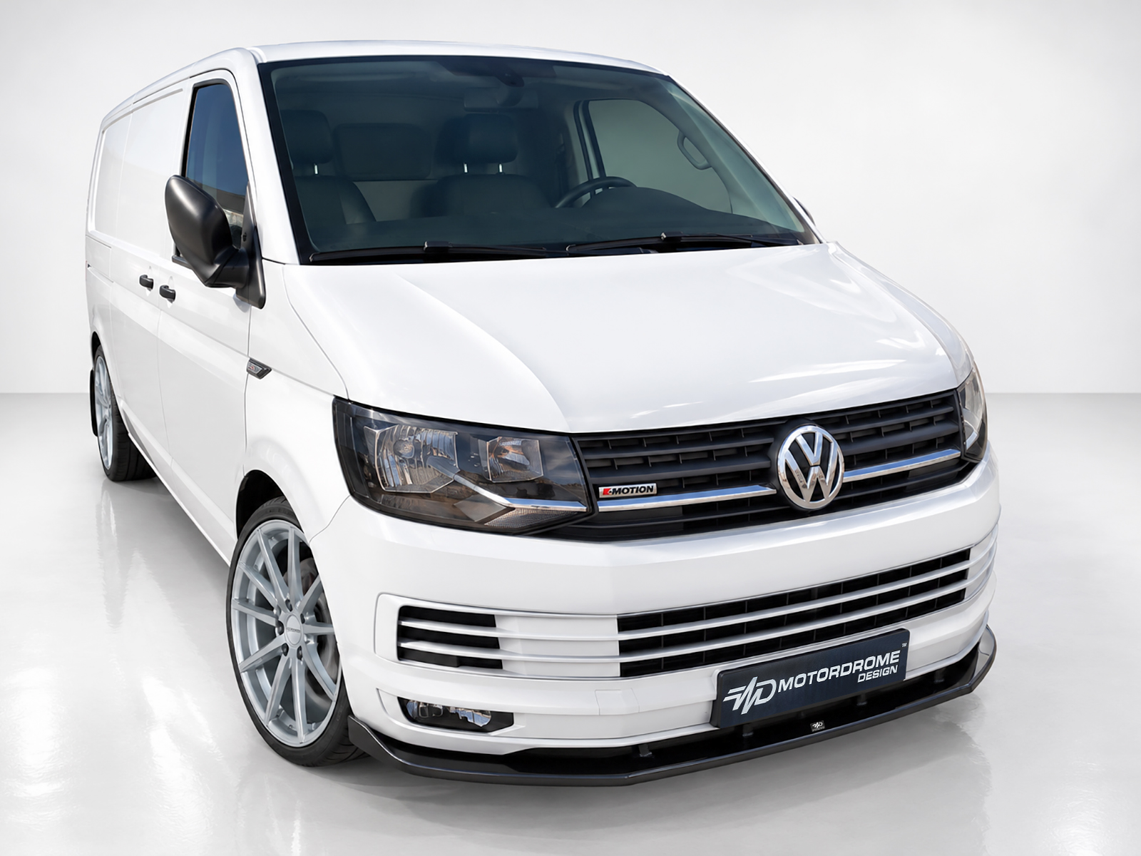 K159-001_1jpg - OPSHOLDERS Front three-quarter view of a white Volkswagen cargo van in a studio setting.