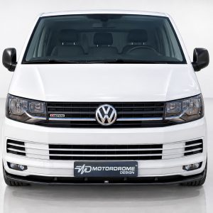 K159-001_2jpg - OPSHOLDERS Front view of a white Volkswagen van in a studio, showing the grille, headlights, and Motordrome Design plate on the bumper.