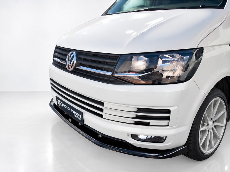 K159-001_3jpg - OPSHOLDERS Front view of a white Volkswagen van showing grille, headlight, and badge