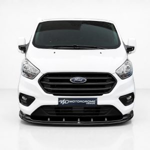 Front view of a white Ford commercial van in a studio with a black grille and Motordrome Design badge plate