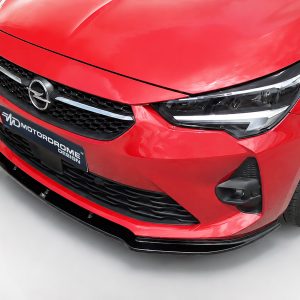 K163-001_2jpg - OPSHOLDERS Close-up of the red Opel car front with emblem, grille, and headlight.