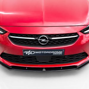 K163-001_3jpg - OPSHOLDERS Front view of a glossy red Opel car showing the grille, headlights, and emblem.