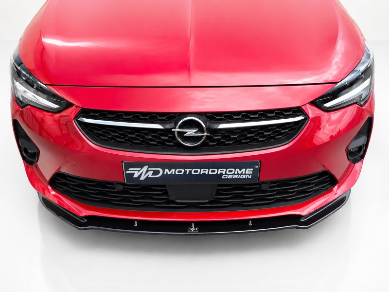 K163-001_3jpg - OPSHOLDERS Front view of a glossy red Opel car showing the grille, headlights, and emblem.