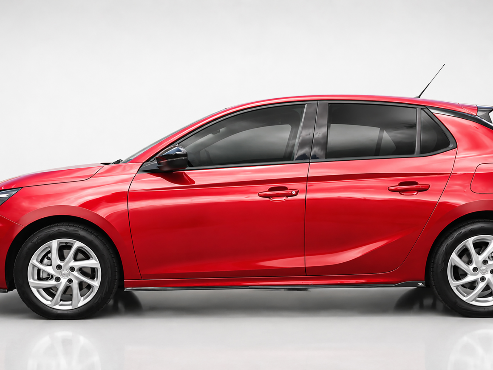 K163-003_2jpg - OPSHOLDERS Side view of a glossy red car showing doors, windows, and alloy wheels against a neutral background.