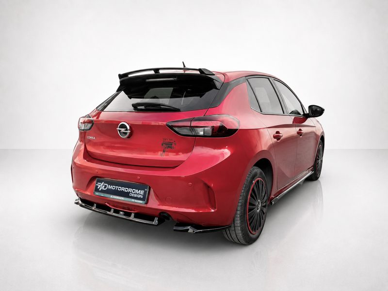 Red Opel Corsa hatchback shown from the rear three-quarter view with a black rear spoiler and aftermarket body kit.