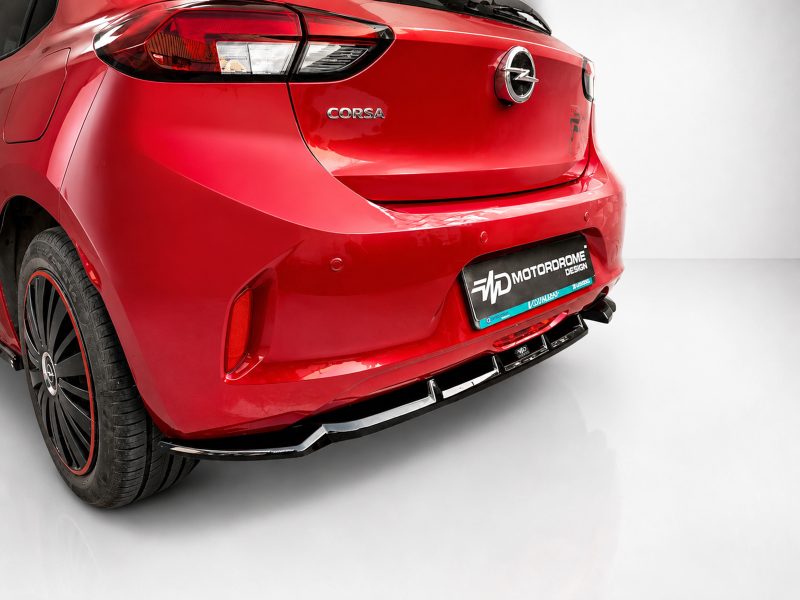 Red Opel Corsa rear view with visible Corsa badge and chrome emblem, showing taillight and customized Motordrome Design license plate frame