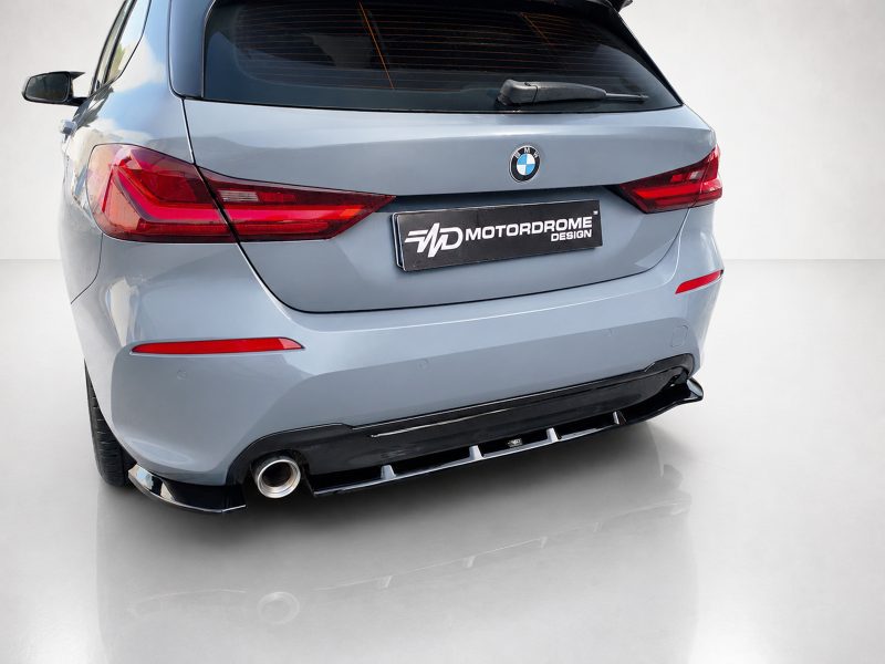 Rear view of a light-blue BMW SUV, showing the MotorDrome Design license plate and red taillights