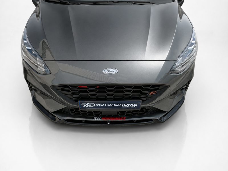 Front view of a gray Ford performance car with a bold honeycomb grille and sleek headlights.