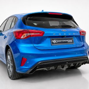 Blue Ford Focus hatchback photographed from the rear-left, showing red tail lights, blue body, and a Motordrome Design plate on a white studio backdrop.