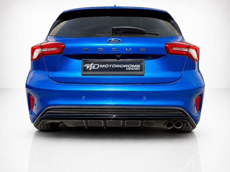 Blue Ford hatchback rear view with branding on the license plate area reading Motordrome Design.