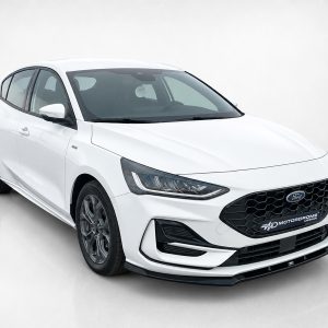 Front-left view of a white Ford sedan in a studio setting, highlighting the black honeycomb grille and sharp headlights.