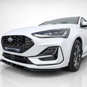 White Ford sedan shown from the front-left in a studio, featuring a black honeycomb grille and sharp LED headlights.