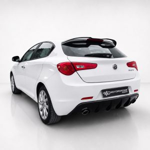 Rear three-quarter view of a white Alfa Romeo Giulietta hatchback in a bright studio setting.