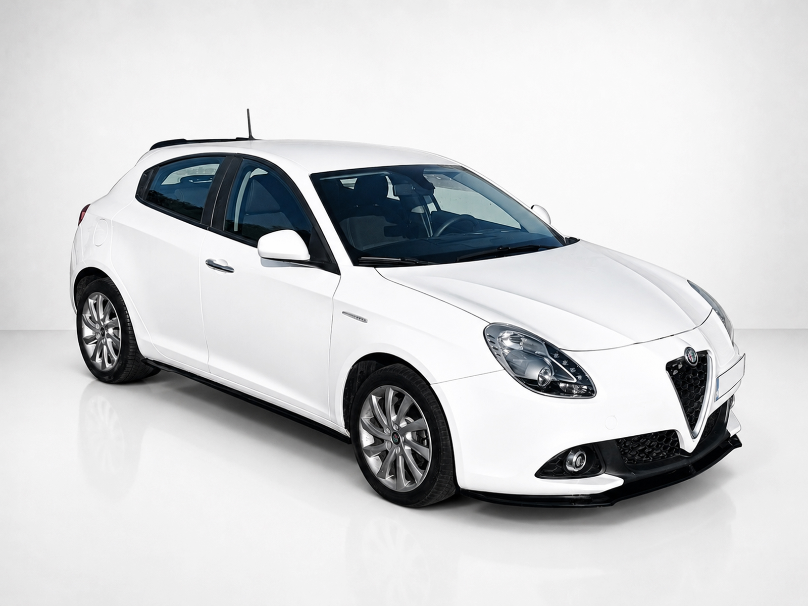 K166-004_2jpg - OPSHOLDERS White hatchback car photographed in a studio, angled to show the front and passenger side.