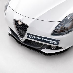 K166-004_3jpg - OPSHOLDERS White sports car front view with honeycomb grille, brand badge, and a Motordrome Design plate on the bumper.