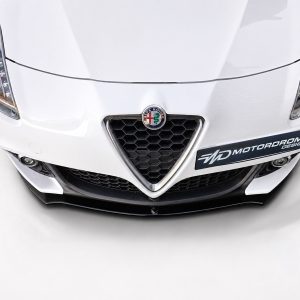 K166-004_4jpg - OPSHOLDERS Front view of a white Alfa Romeo with a honeycomb front grille, emblem at center, and a black bumper with an 'MD MOTORDROME DESIGN' sticker on the right side