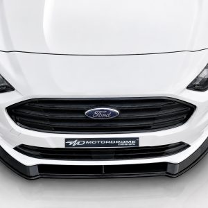 K167-001_3jpg - OPSHOLDERS Front view of a white Ford car with a black grille and Ford emblem on the front bumper area with a glossy finish.