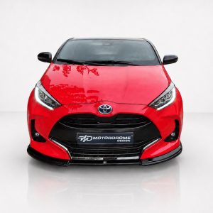 Front view of a red Toyota with black grille and emblem, set against a white studio backdrop.] ,