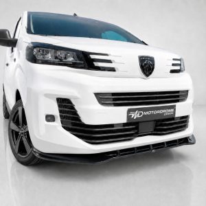 White Peugeot van shown from a front-left angle with bold grille and custom MD Motorodrome plate on the bumper