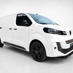 White cargo van with black wheels on a light gray studio floor, angled from the front-left side.