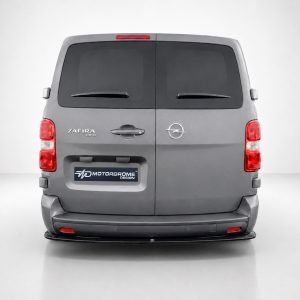 Rear view of a gray Opel van (Zafira Life) with rear doors closed and a Motordrome Design plate visible on the bumper area.