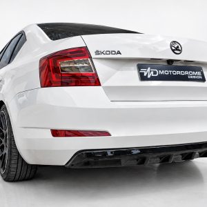 Rear view of a white Skoda Octavia with a customized plate reading 'MOTORDROME DESIGN' and dark tinted rear window