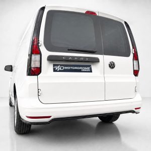 Rear view of a white VW Caddy van with the CADDY badge and Motordrome Design logo on the tailgate, in a studio setting.