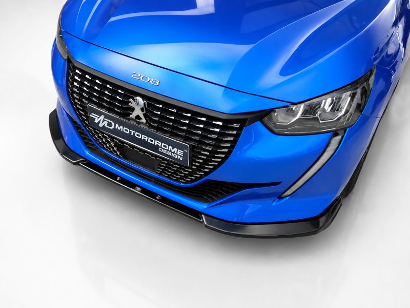 Close-up of a blue Peugeot 208 front grille with the logo and sleek headlight visible