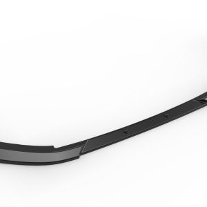 Long black curved car bumper lip spoiler lying on a white surface, showing mounting edges and aerodynamic shape.
