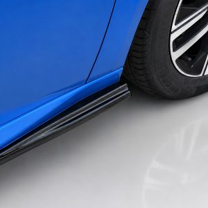 Close-up of a blue car's side skirt and alloy wheel with tire