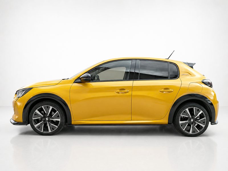 Yellow hatchback car shown in a side profile in a studio setting with black trim and large alloy wheels.