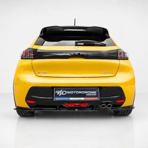 Rear view of a bright yellow Peugeot 208 GTline with black rear bumper, taillights, and dual exhausts in a studio setting.