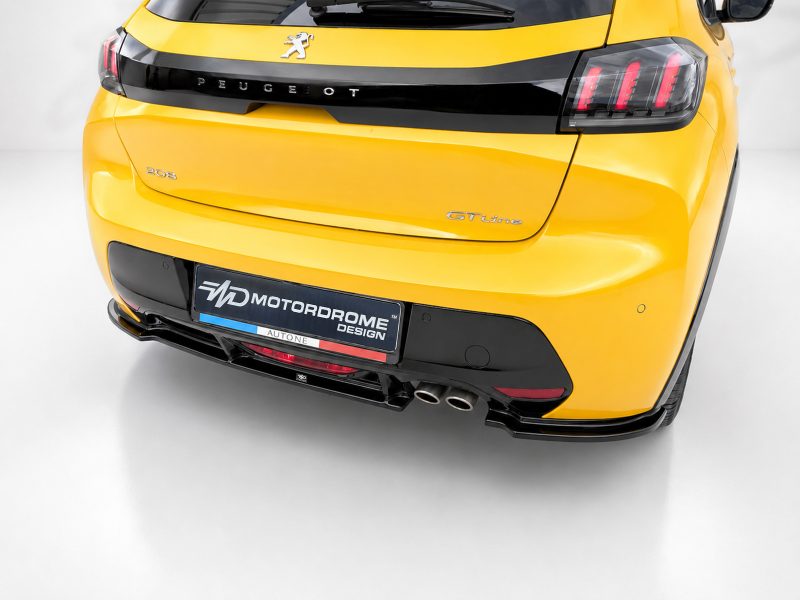 Rear view of a bright yellow Peugeot 208 GT Line with black rear hatch trim, distinctive taillights, and dual exhausts, showing a Motordrome Design plate at the bumper.