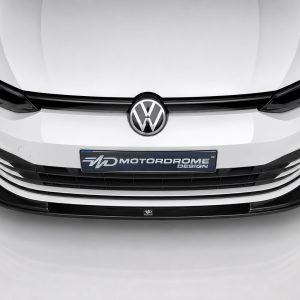 K174-001_2jpg - OPSHOLDERS Front view of a white Volkswagen with a black grille and a Motordrome Design plate in the center of the bumper.
