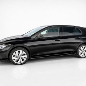 Black compact hatchback car shown in a studio setting from the side view, glossy finish highlighted by reflections
