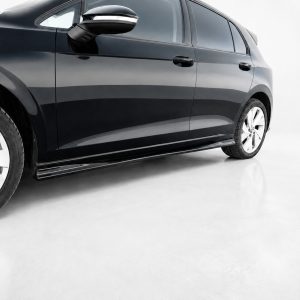 Side view of a glossy black car showing doors, mirror, and alloy wheels on a light background.