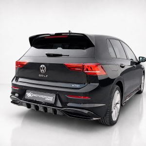 K174-004_2jpg - OPSHOLDERS Black Volkswagen Golf eTSI wagon viewed from rear-left in a studio; badge reads GOLF and eTSI on the tail. Plate shows Motordrome Design.