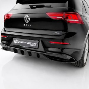 K174-004_3jpg - OPSHOLDERS Rear view of a black VW Golf eTSI with a racing-style diffuser and red taillights, displaying a Motordrome Design plate on the bumper.