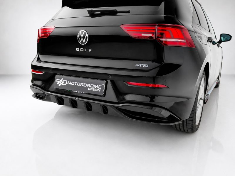 K174-004_3jpg - OPSHOLDERS Rear view of a black VW Golf eTSI with a racing-style diffuser and red taillights, displaying a Motordrome Design plate on the bumper.