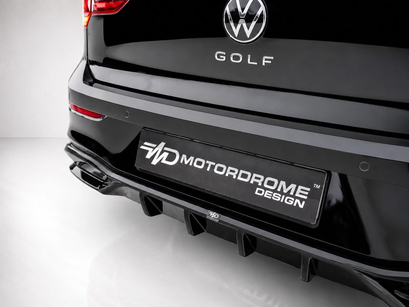 K174-004_4jpg - OPSHOLDERS Rear view of a glossy black VW Golf showing a Motordrome Design license plate and sporty rear bumper/diffuser