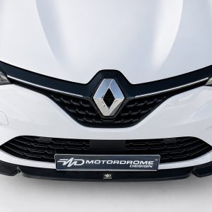 Front view of a white Renault car showing the grille and diamond emblem prominently centered