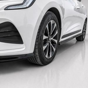 Close-up of a white car's front left wheel and air intake, featuring a multi-spoke alloy rim and low-profile tire.