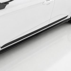 Side view of a white car showing a black running board and alloy wheel on the right side of the image.